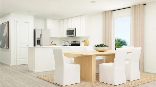 a kitchen with kitchen island a white counter top space and a refrigerator