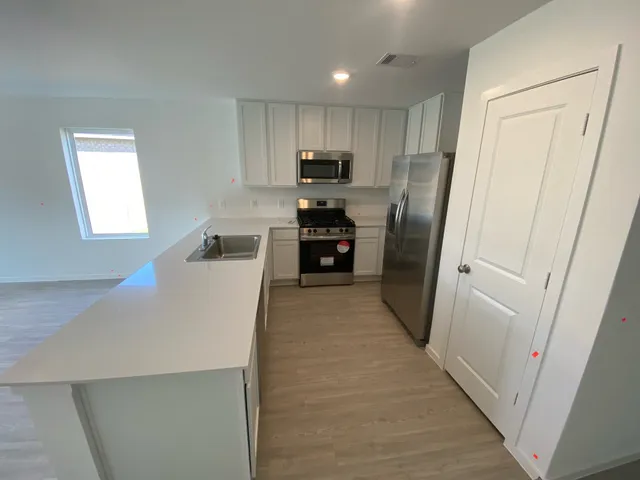 a kitchen with a stove and a refrigerator