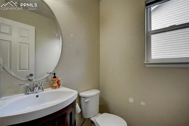 a bathroom with a sink mirror and toilet