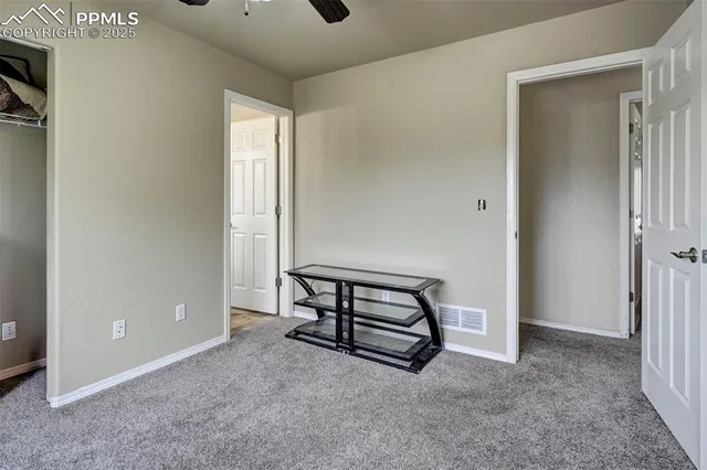 an empty room with windows and closet