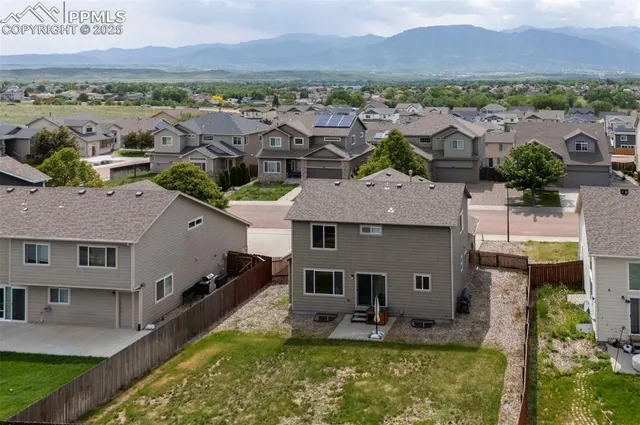 an aerial view of house with yard swimming pool and mountains