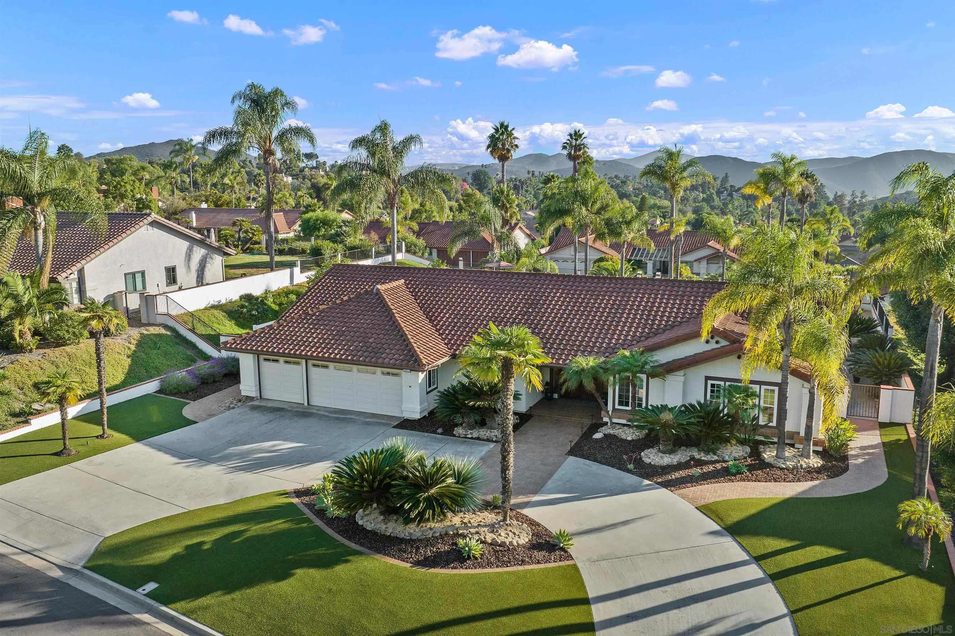 a view of a house with a yard and a garden