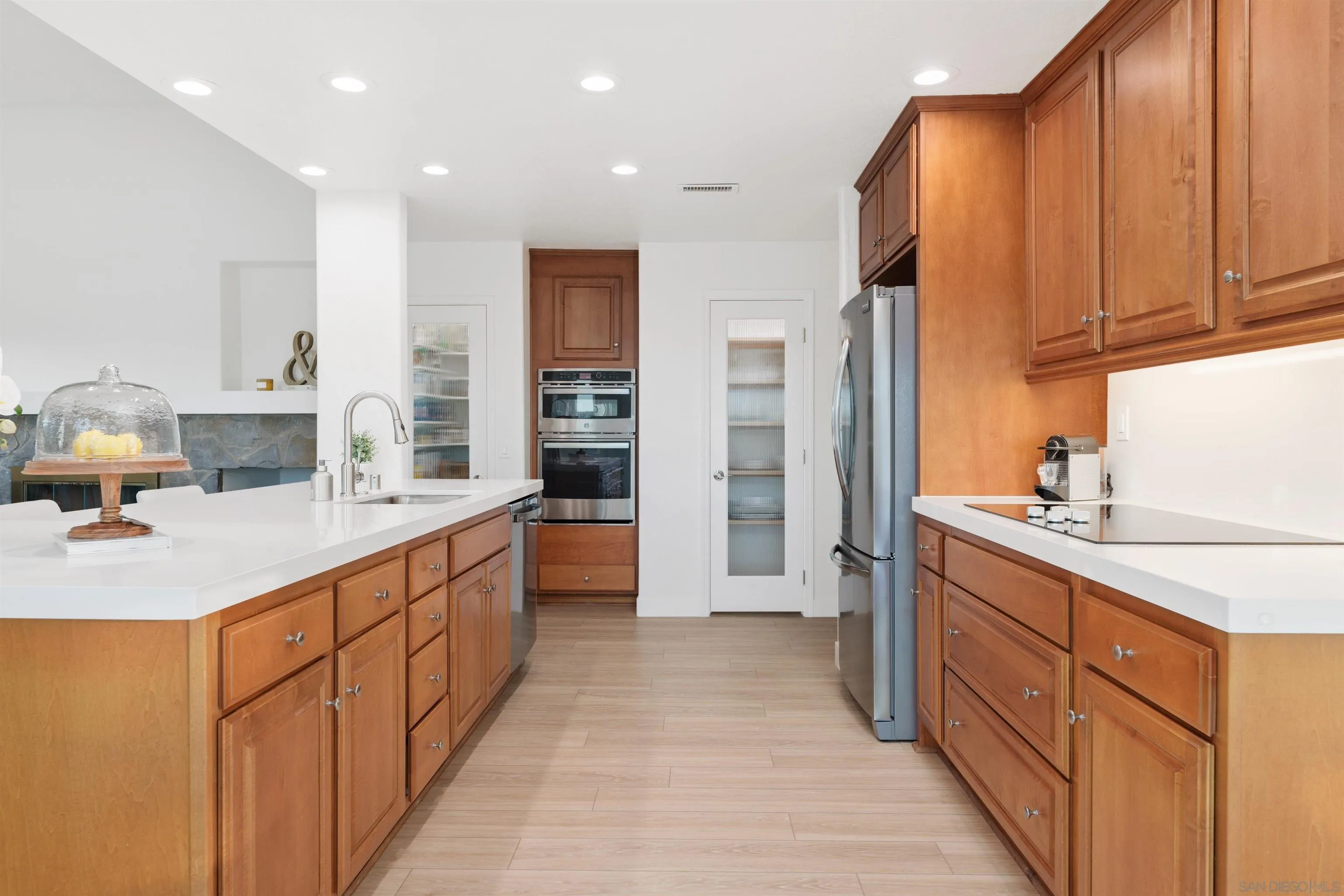 1611 Stoneridge Circle Escondido, CA 92029 - Photo 11 of 30 a kitchen with stainless steel appliances kitchen island granite countertop a sink and cabinets