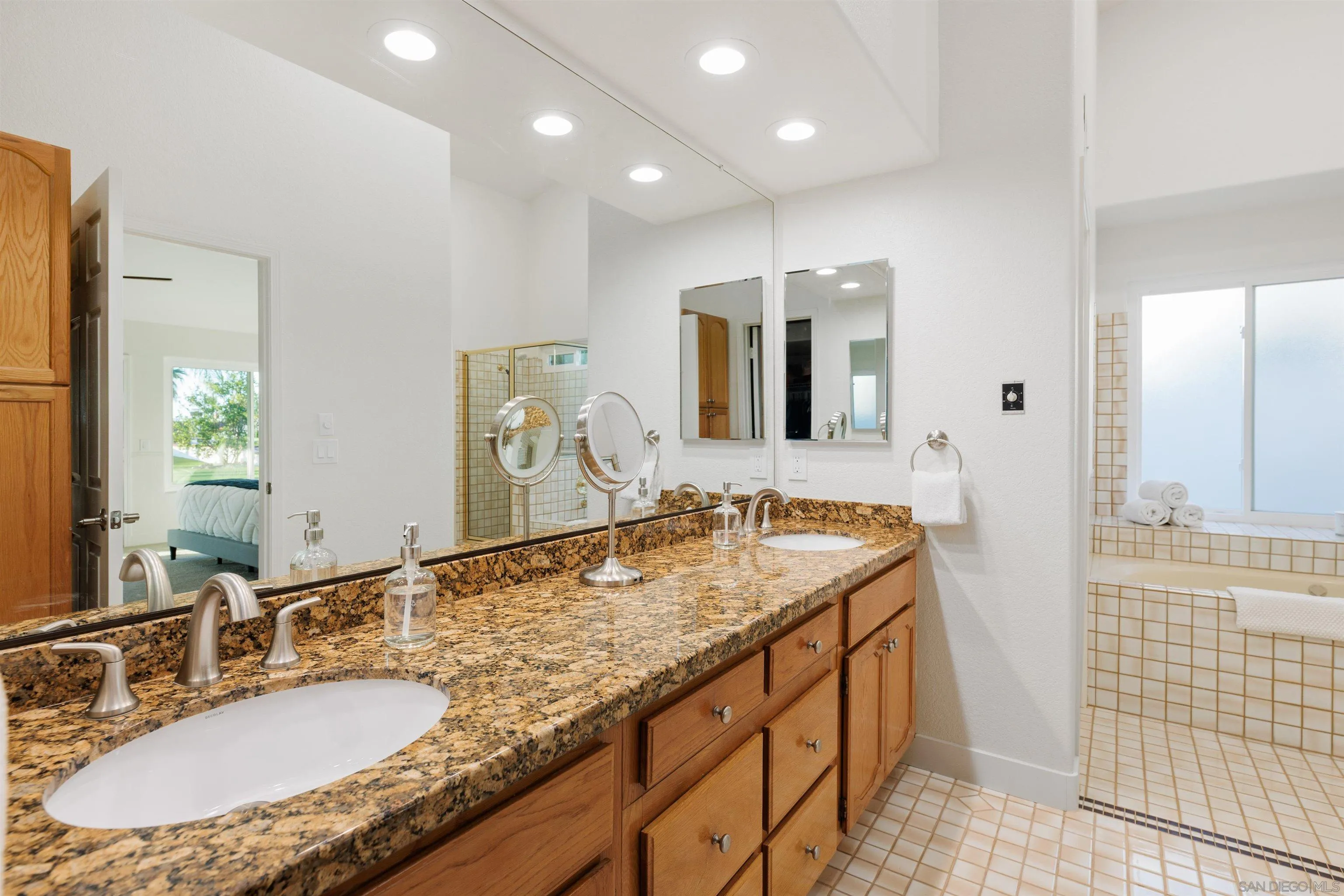 1611 Stoneridge Circle Escondido, CA 92029 - Photo 17 of 30 a bathroom with a granite countertop sink and a mirror