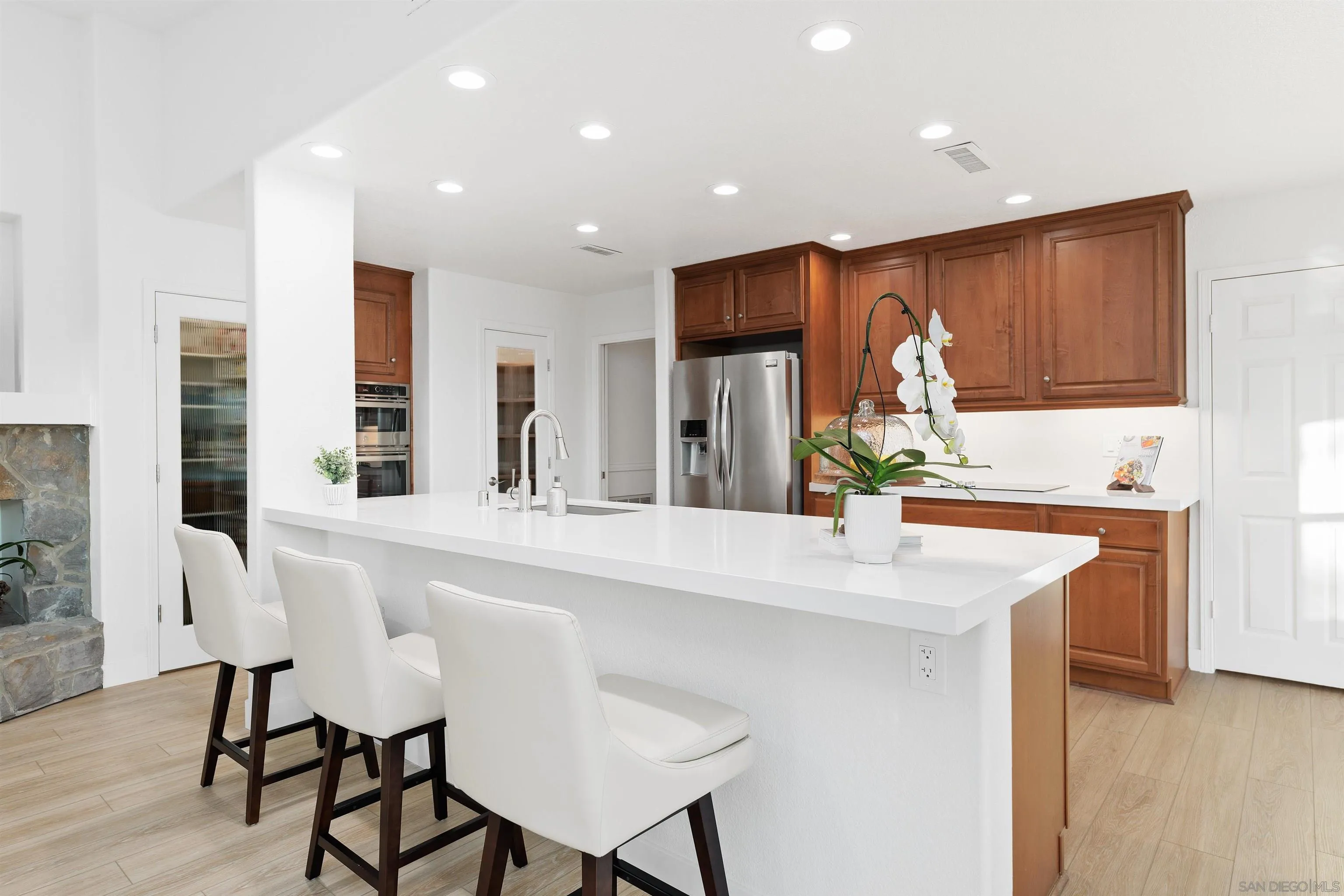 1611 Stoneridge Circle Escondido, CA 92029 - Photo 10 of 30 a kitchen with kitchen island a sink table and chairs