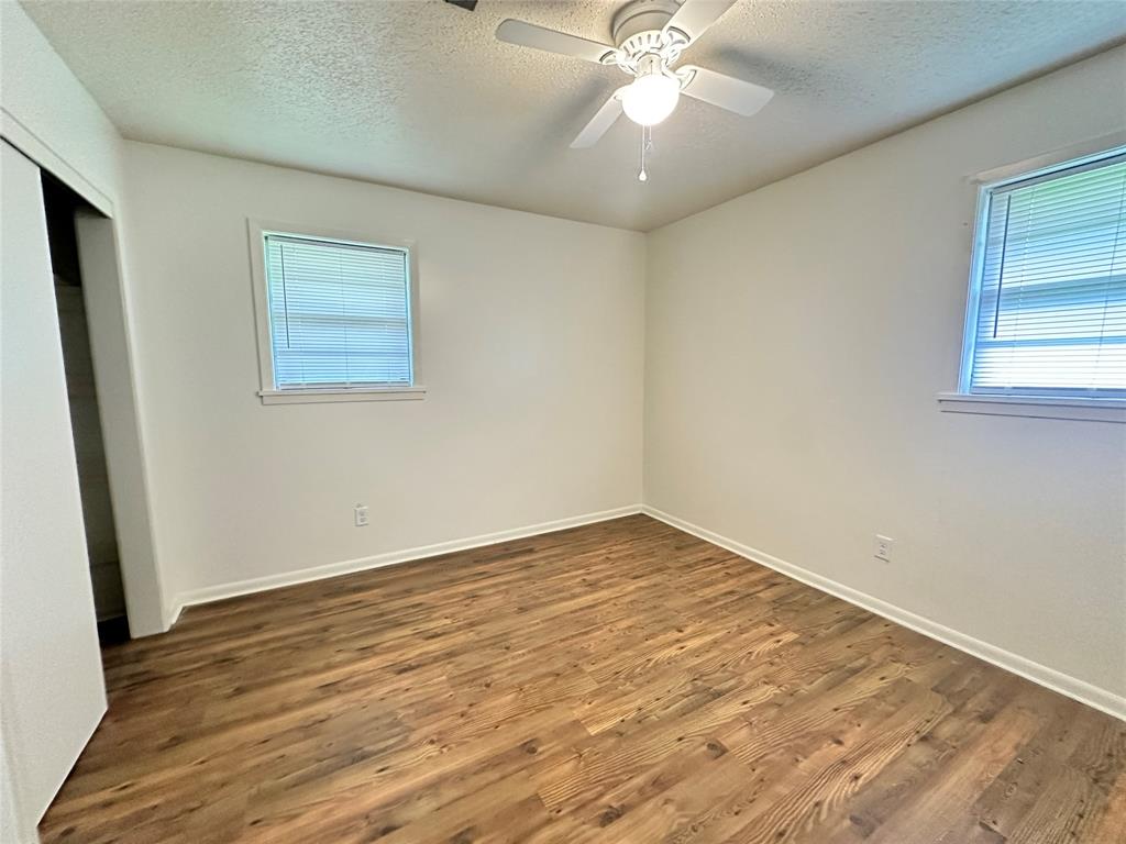 127 Lawrence Drive Haughton, LA 71037 - Photo 13 of 16 a view of an empty room with wooden floor and a window