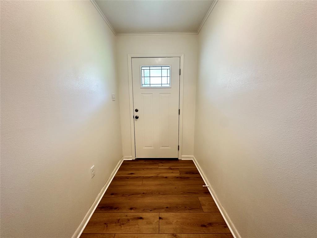 127 Lawrence Drive Haughton, LA 71037 - Photo 4 of 16 a view of a hallway with wooden floor and a white door