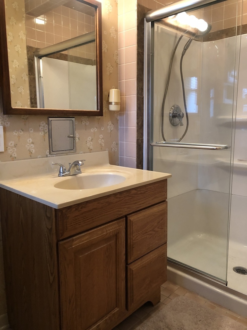 3449 Phillips Avenue Steger, IL 60475 - Photo 15 of 25 a bathroom with a sink mirror and vanity