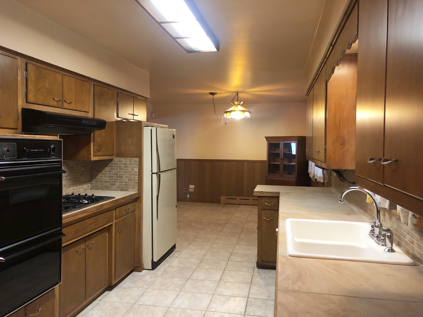 3449 Phillips Avenue Steger, IL 60475 - Photo 8 of 25 a kitchen with kitchen island granite countertop a sink and cabinets