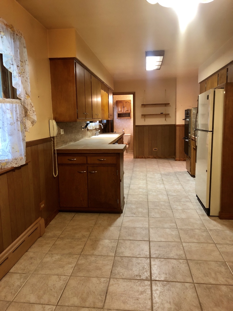 3449 Phillips Avenue Steger, IL 60475 - Photo 9 of 25 a kitchen with stainless steel appliances granite countertop a refrigerator and a stove