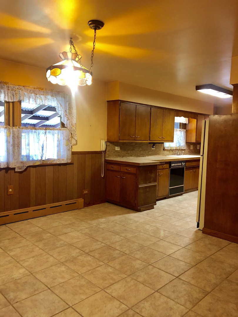 3449 Phillips Avenue Steger, IL 60475 - Photo 10 of 25 a view of a kitchen with a sink cabinets and stainless steel appliances