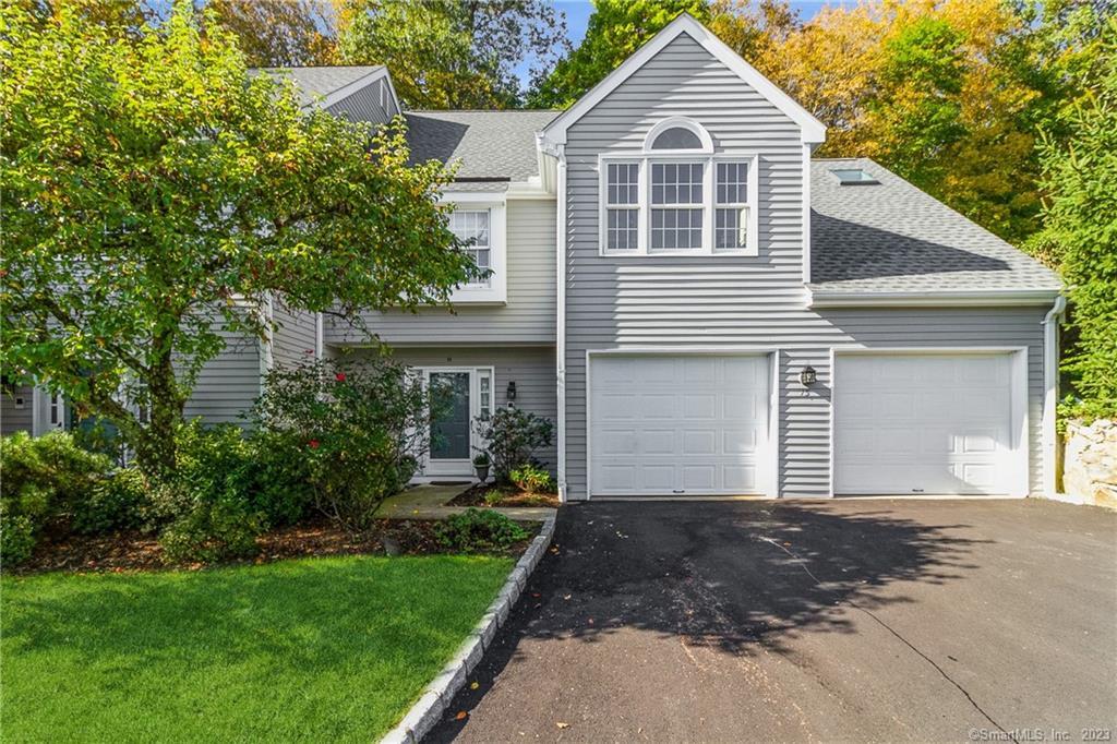 120 Prospect Street, Unit 15 Ridgefield, CT 06877 - Photo 1 of 1 a front view of a house with a yard and garage
