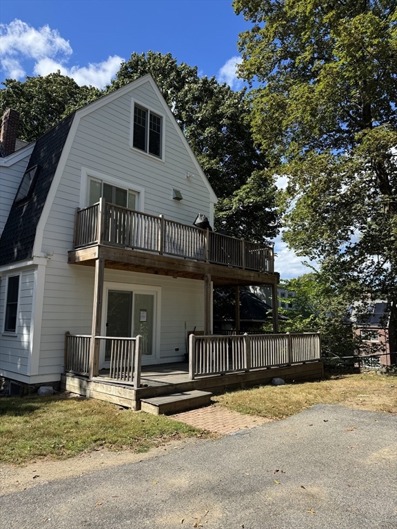 62 Crosby Road, Unit 1 Newton, MA 02467 - Photo 12 of 12 a view of a house with a yard and large tree