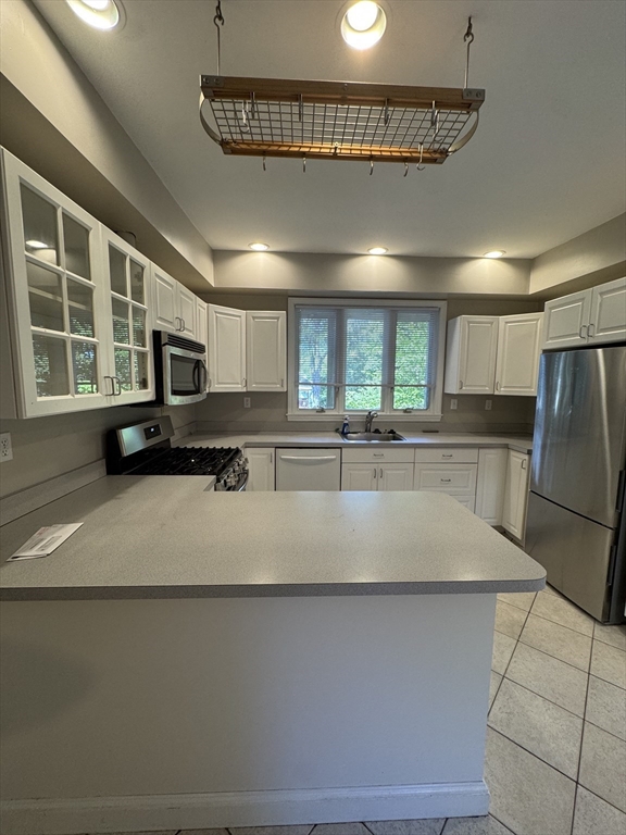 62 Crosby Road, Unit 1 Newton, MA 02467 - Photo 4 of 12 a large white kitchen with a large window