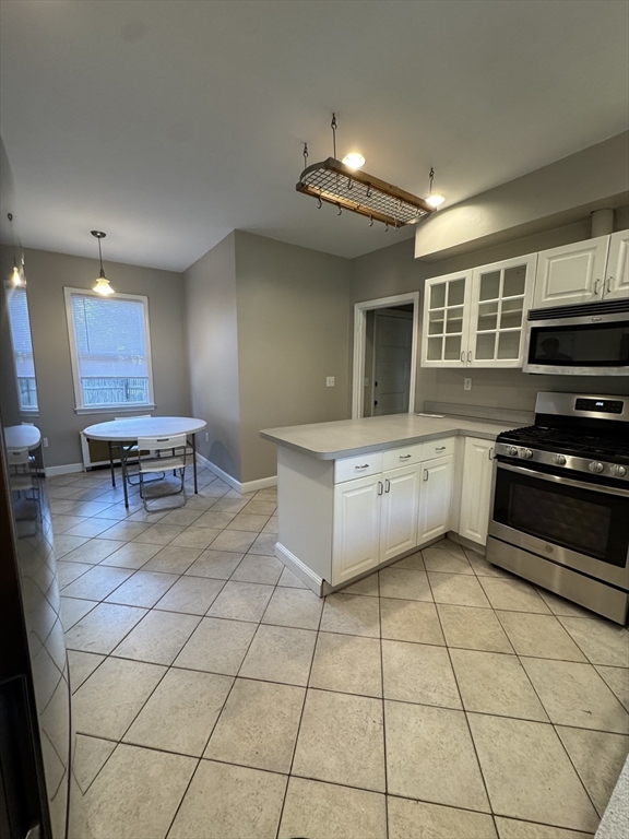 62 Crosby Road, Unit 1 Newton, MA 02467 - Photo 5 of 12 a kitchen with a sink a stove and cabinets