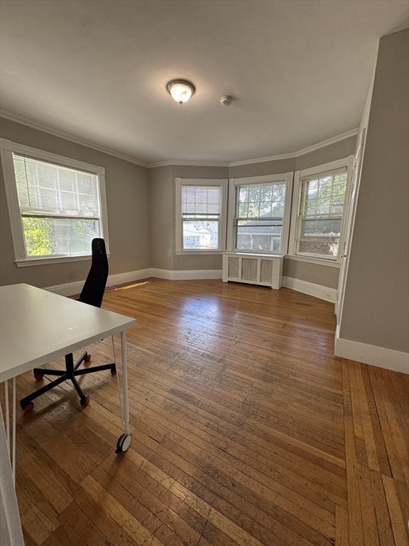 62 Crosby Road, Unit 1 Newton, MA 02467 - Photo 8 of 12 a living room with couches bookshelf and a large window