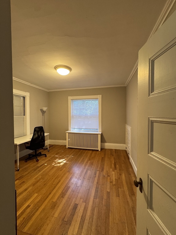 62 Crosby Road, Unit 1 Newton, MA 02467 - Photo 9 of 12 a view of empty room with a window and wooden floor