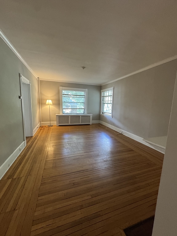 62 Crosby Road, Unit 1 Newton, MA 02467 - Photo 10 of 12 a view of empty room with wooden floor and fan