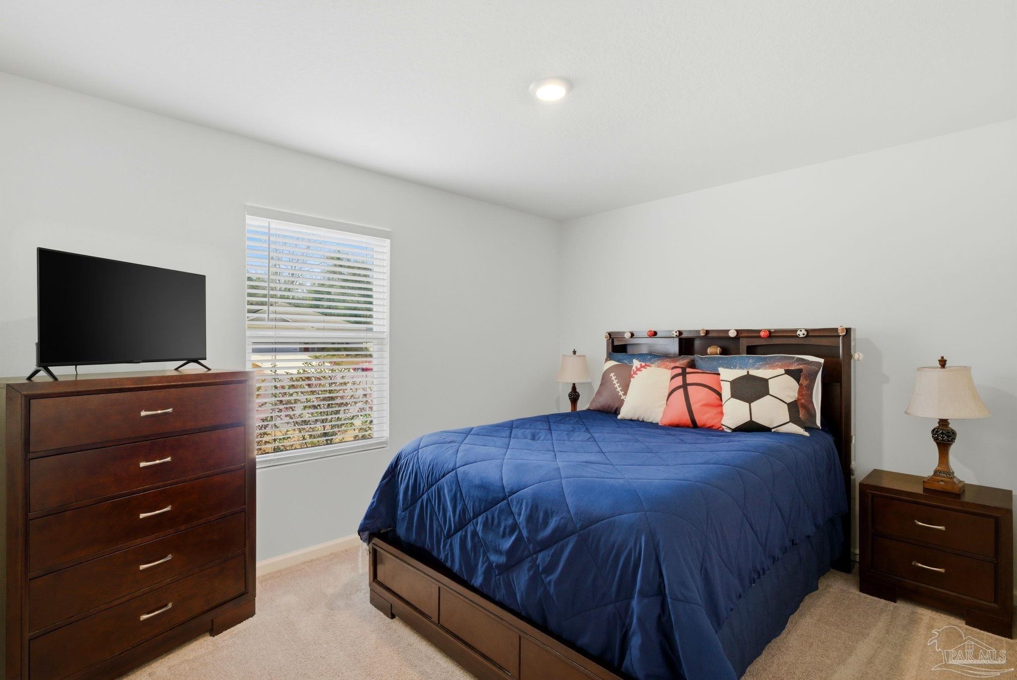 7804 Maxton Road Pensacola, FL 32514 - Photo 13 of 20 a bedroom with a bed and a flat screen tv