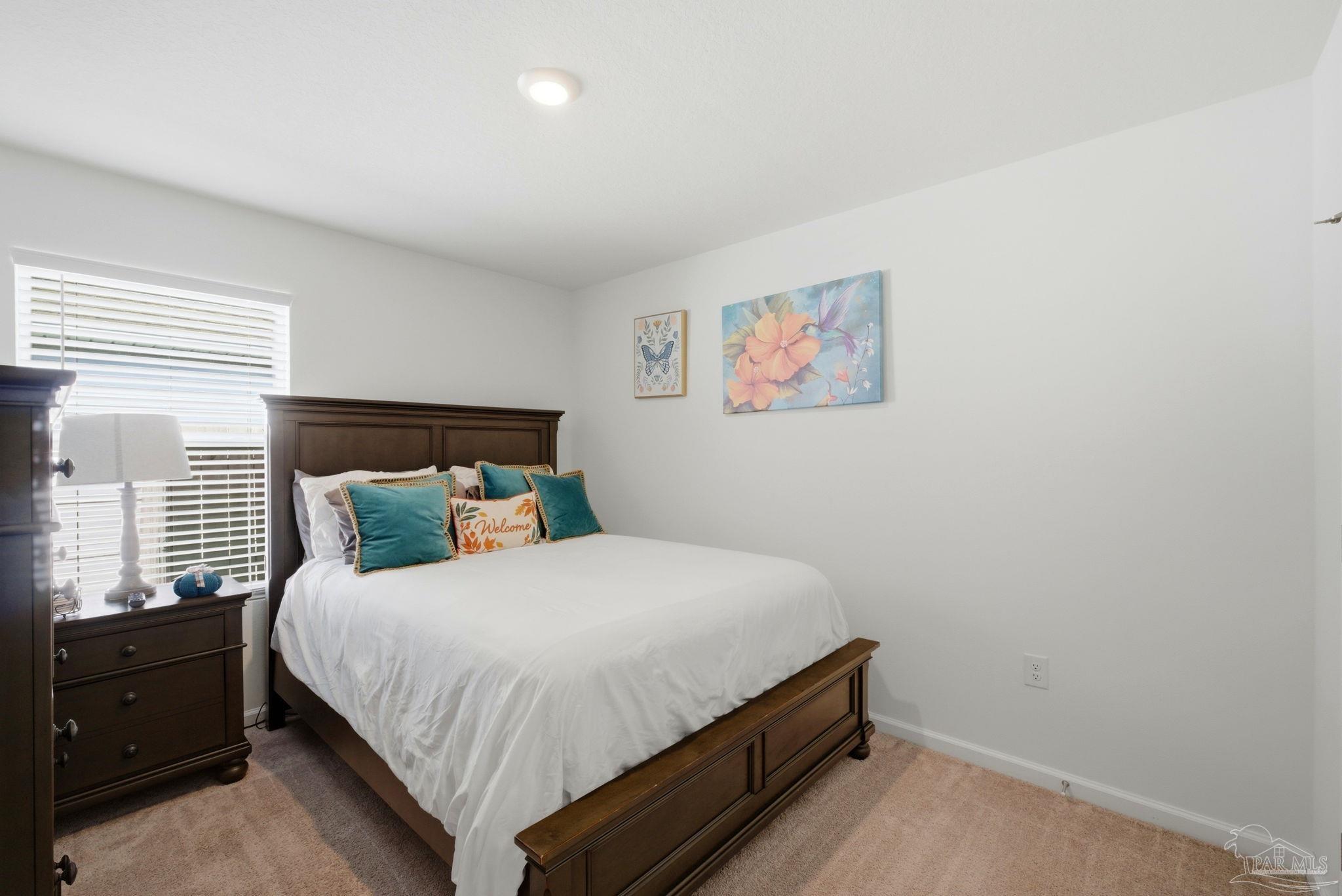 7804 Maxton Road Pensacola, FL 32514 - Photo 16 of 20 a bed room with a bed and a window