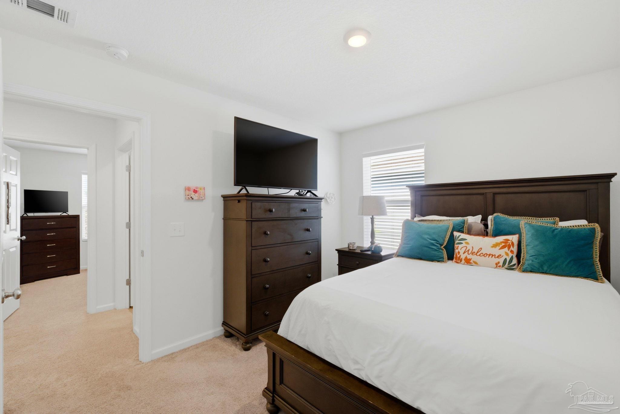 7804 Maxton Road Pensacola, FL 32514 - Photo 17 of 20 a bedroom with a bed and a flat screen tv