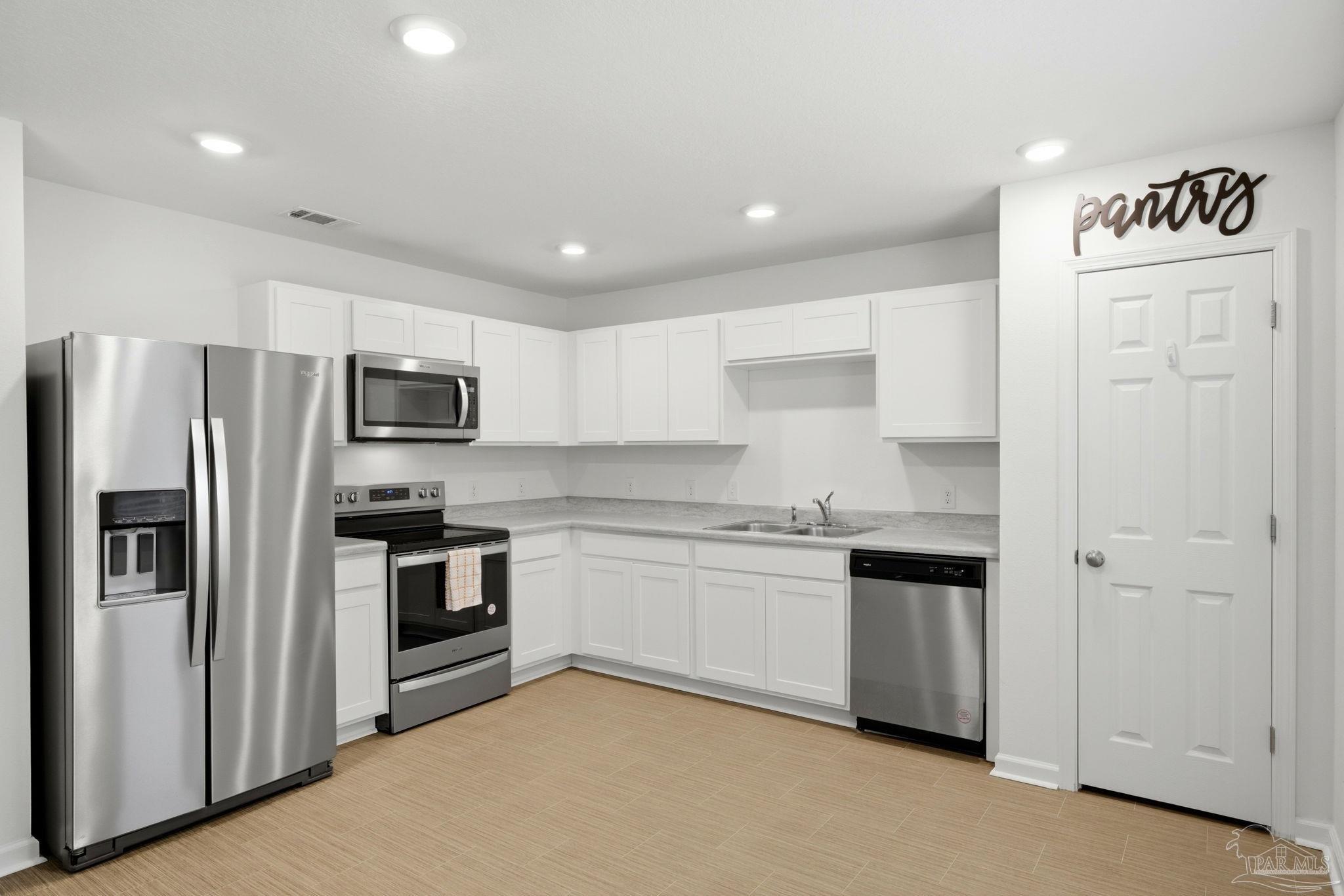 7804 Maxton Road Pensacola, FL 32514 - Photo 5 of 20 a kitchen with stainless steel appliances granite countertop a refrigerator and a stove top oven