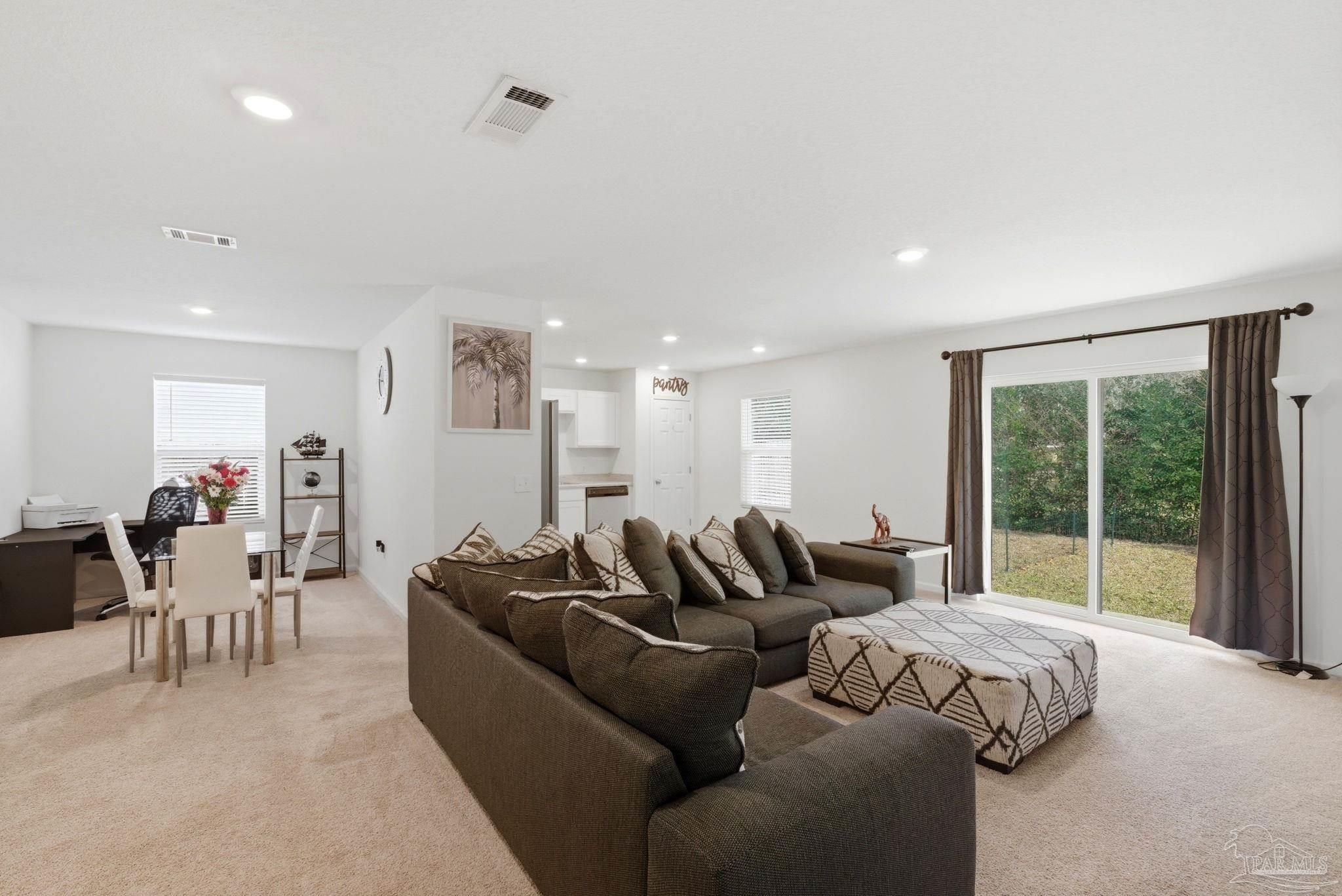7804 Maxton Road Pensacola, FL 32514 - Photo 6 of 20 a living room with furniture and large windows