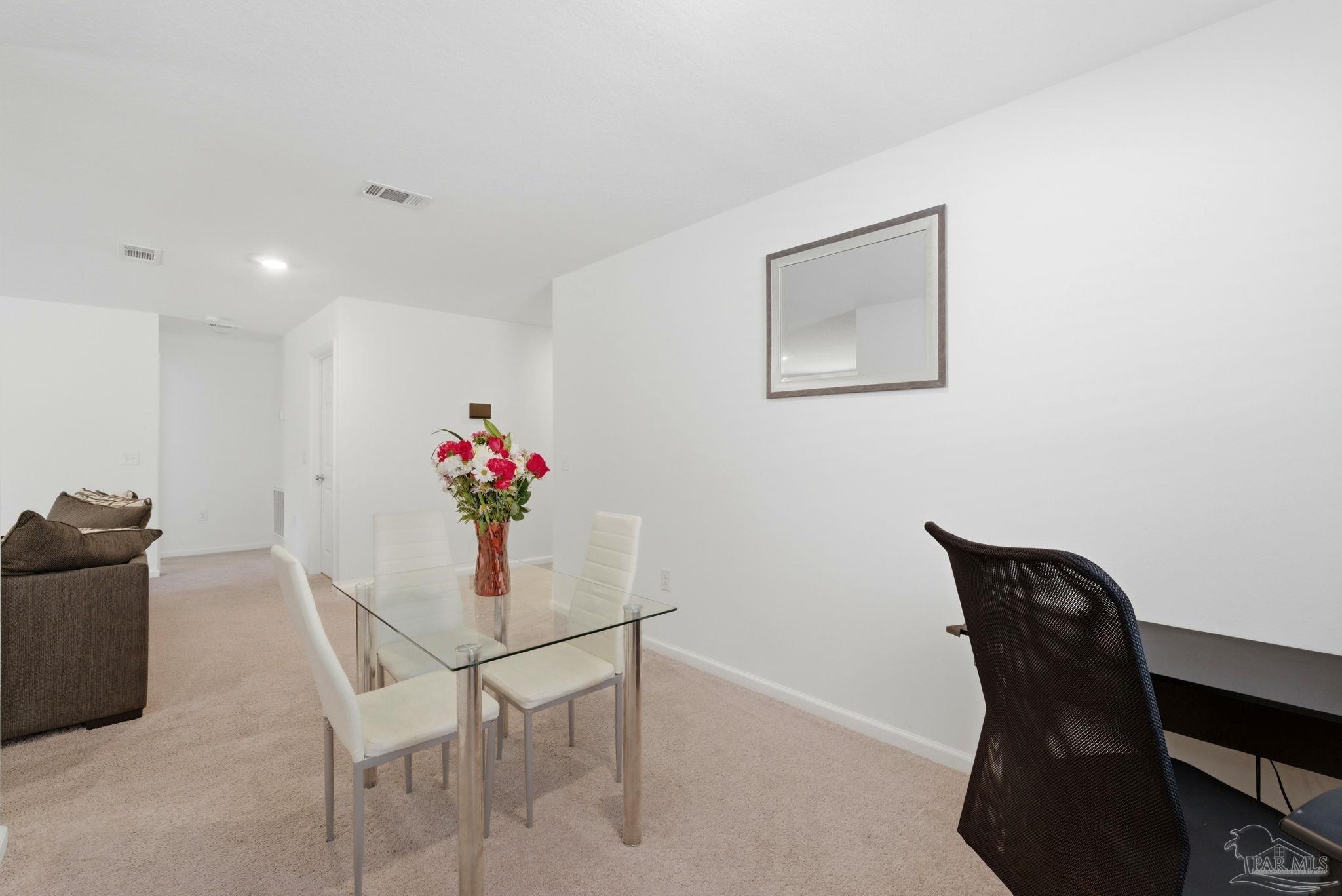 7804 Maxton Road Pensacola, FL 32514 - Photo 7 of 20 a dining room with furniture and wooden floor