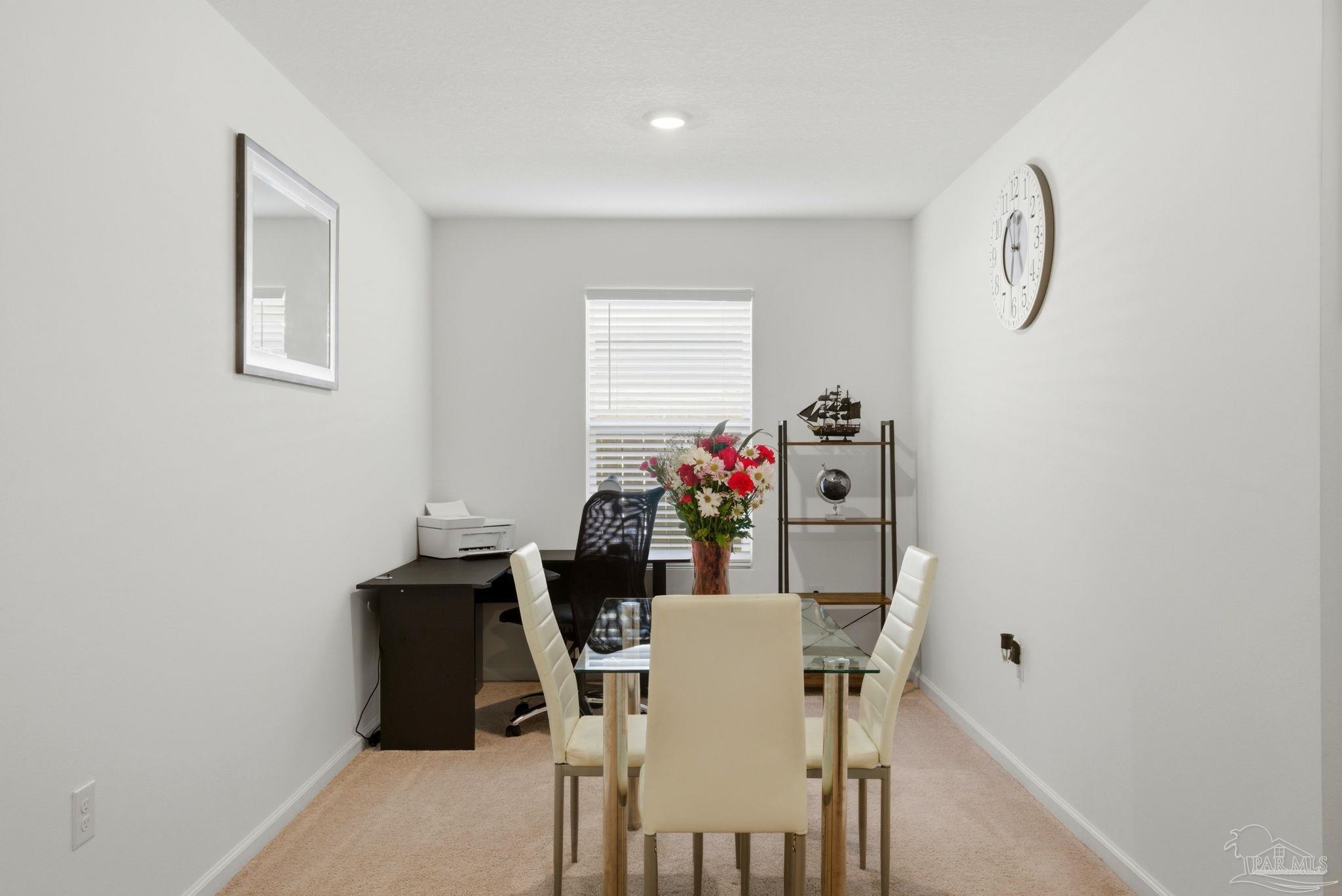 7804 Maxton Road Pensacola, FL 32514 - Photo 8 of 20 a view of a dining room with furniture and a potted plant