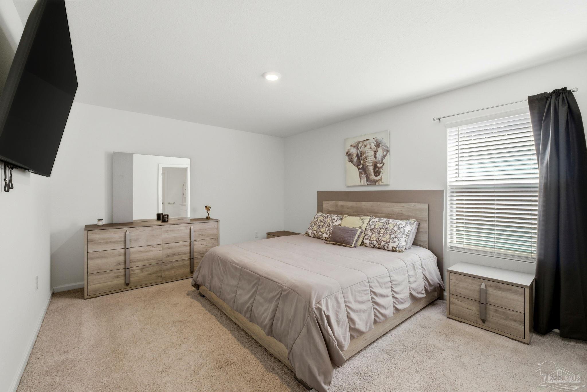 7804 Maxton Road Pensacola, FL 32514 - Photo 9 of 20 a bedroom with a bed and a flat screen tv