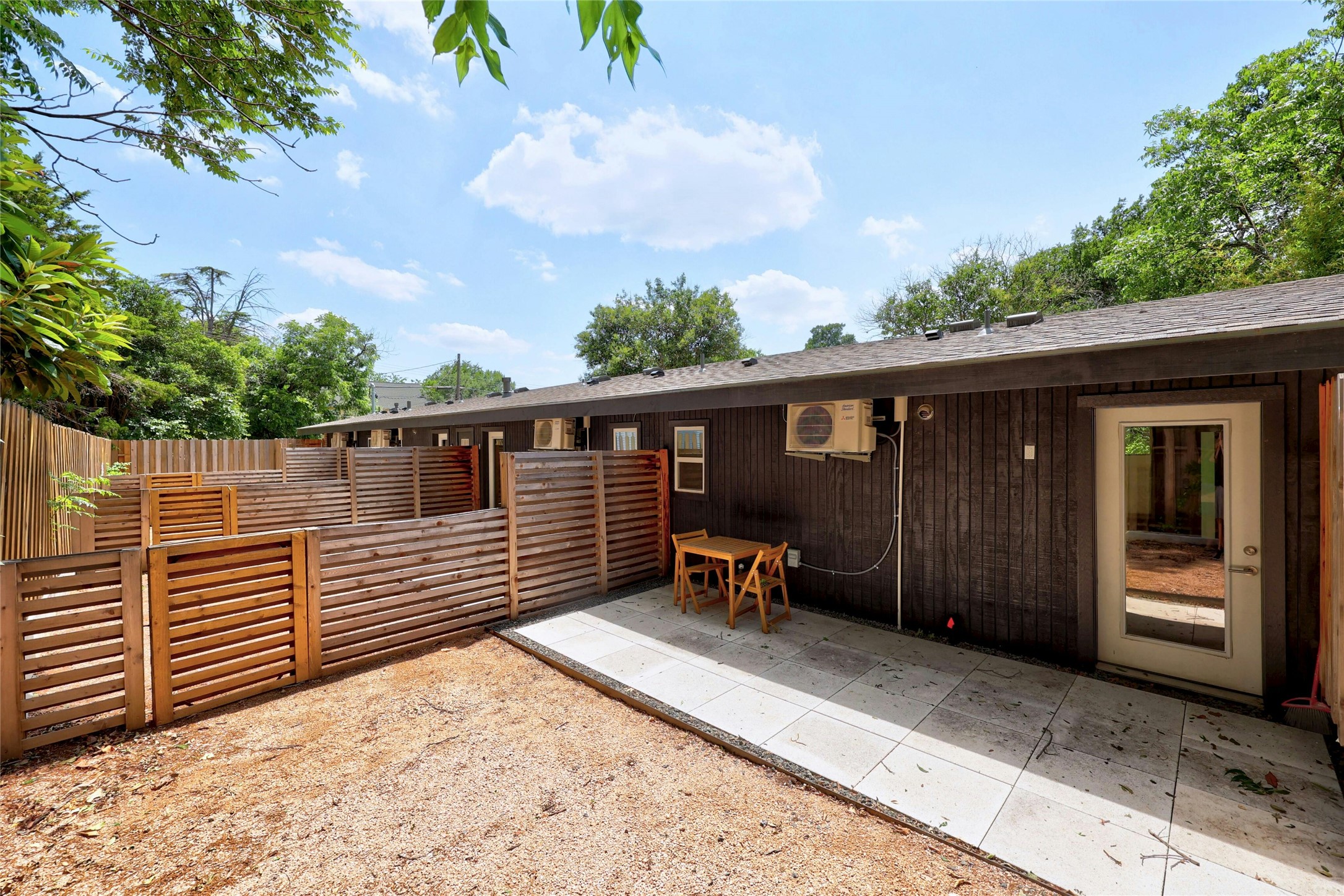 2201 Leon Street Austin, TX 78705 - Photo 25 of 30 A private backyard retreat offers a spacious patio for outdoor living, enclosed by modern fencing.