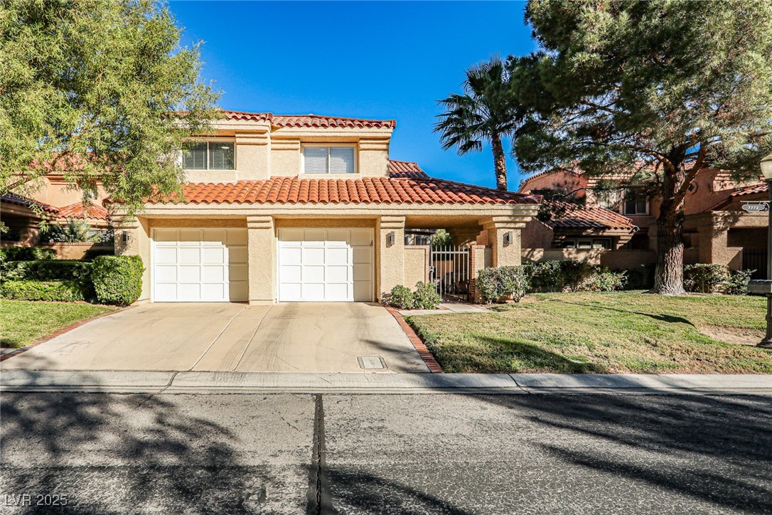 7772 Boca Raton Drive Las Vegas, NV 89113 - Photo 1 of 40 Mediterranean / spanish home featuring stucco siding, a front lawn, driveway, a garage, and a tile roof