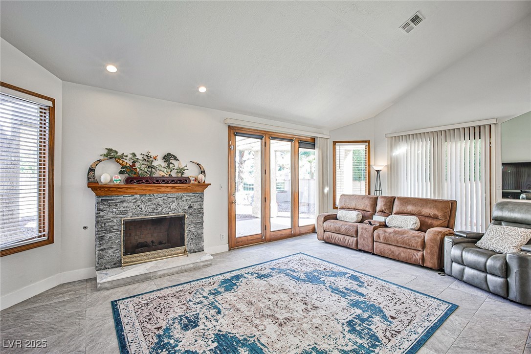 7772 Boca Raton Drive Las Vegas, NV 89113 - Photo 20 of 40 Living room with healthy amount of natural light, a fireplace, vaulted ceiling, and recessed lighting