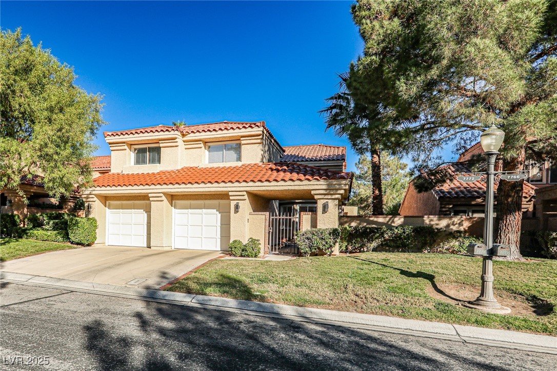 7772 Boca Raton Drive Las Vegas, NV 89113 - Photo 2 of 40 Mediterranean / spanish home featuring a front yard, stucco siding, driveway, a tile roof, and a garage