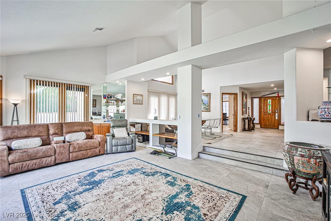7772 Boca Raton Drive Las Vegas, NV 89113 - Photo 21 of 40 Living room with high vaulted ceiling and recessed lighting