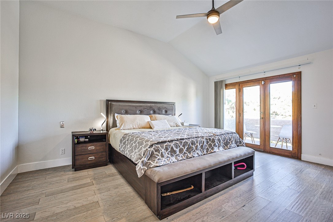 7772 Boca Raton Drive Las Vegas, NV 89113 - Photo 29 of 40 Bedroom with access to outside, lofted ceiling, light wood-style floors, a ceiling fan, and french doors