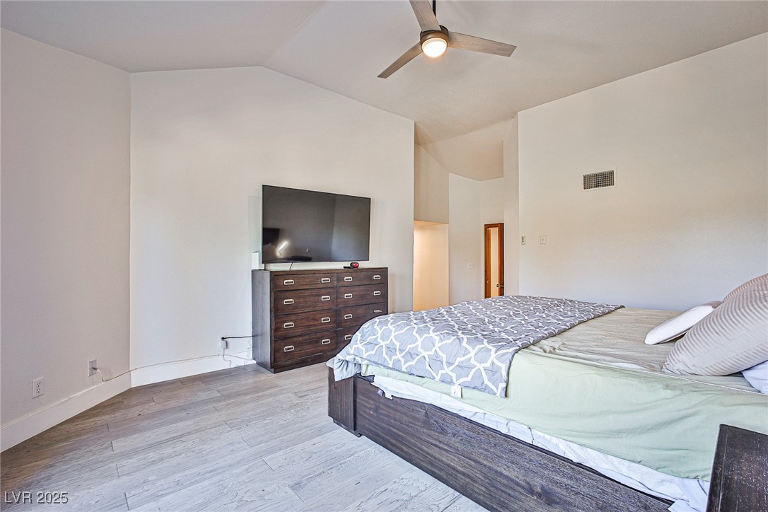 7772 Boca Raton Drive Las Vegas, NV 89113 - Photo 31 of 40 Bedroom with light wood-type flooring, lofted ceiling, and ceiling fan