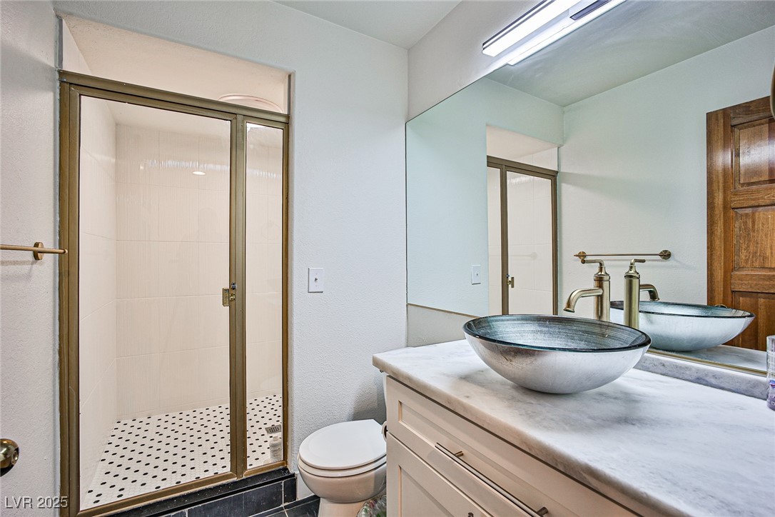 7772 Boca Raton Drive Las Vegas, NV 89113 - Photo 36 of 40 Bathroom with vanity, a shower stall, and dark tile patterned floors