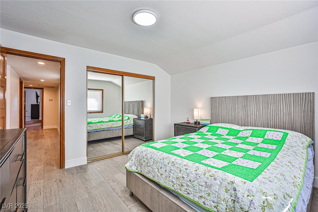 7772 Boca Raton Drive Las Vegas, NV 89113 - Photo 38 of 40 Bedroom featuring vaulted ceiling, light wood finished floors, and a closet