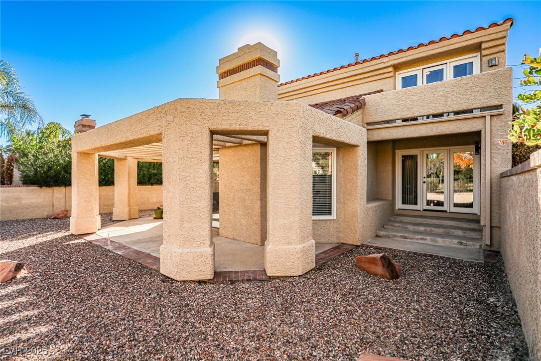 7772 Boca Raton Drive Las Vegas, NV 89113 - Photo 6 of 40 Back of house featuring stucco siding, a patio, french doors, and a chimney