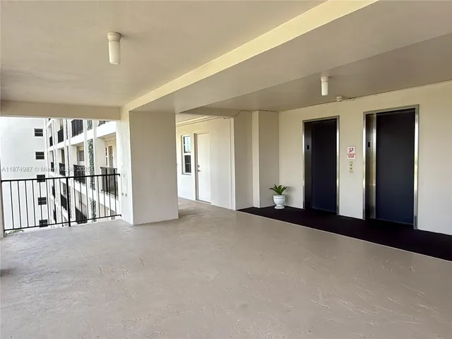a kitchen with stainless steel appliances kitchen island granite countertop a refrigerator and a sink