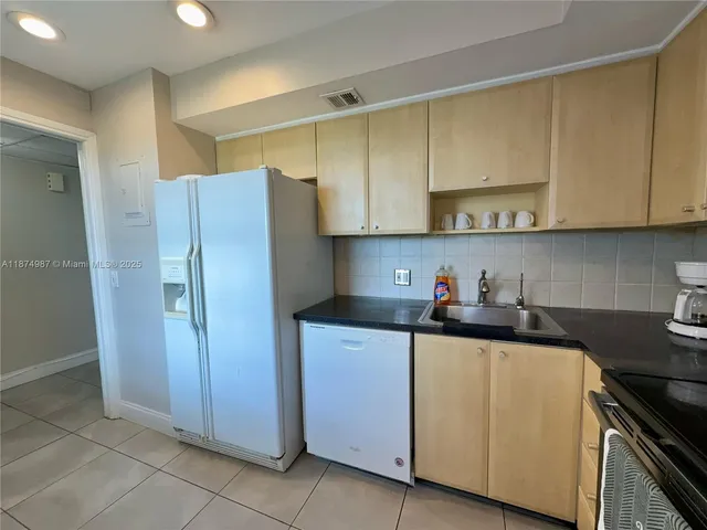 a lobby with furniture and chandelier