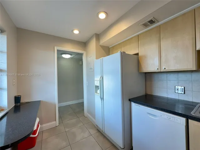 a view of a livingroom with a large window and couch