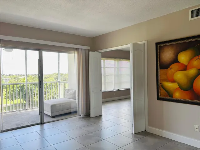 a view of a room with closet and a ceiling fan