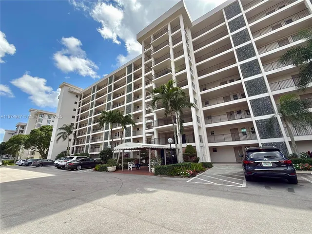 a view of a patio with table and chairs potted plants with wooden floor