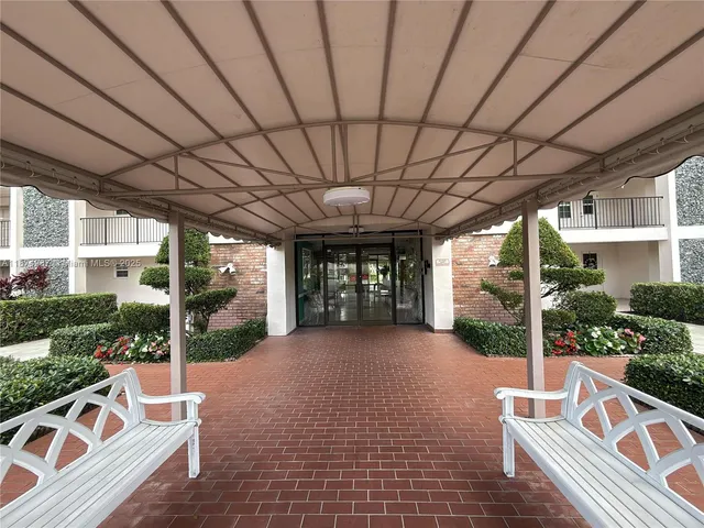 a kitchen with granite countertop a refrigerator and a sink
