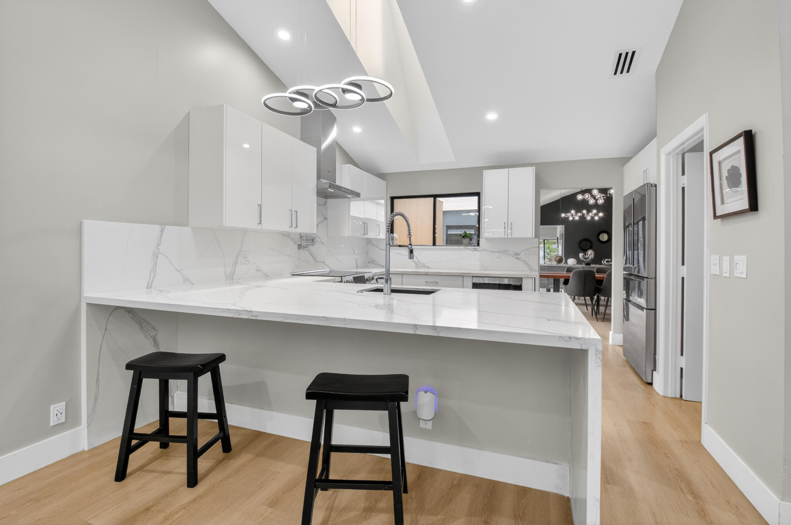 7374 Woodmont Court Boca Raton, FL 33434 - Photo 5 of 95 a kitchen with kitchen island a appliances dining table and chairs