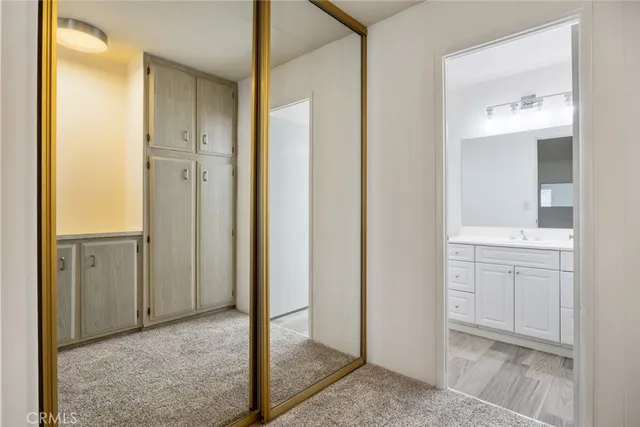 a bathroom with a sink a toilet and a large mirror