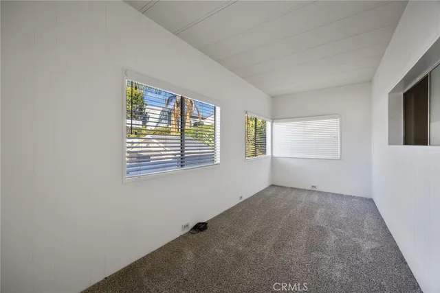a bathroom with a granite countertop toilet sink and mirror