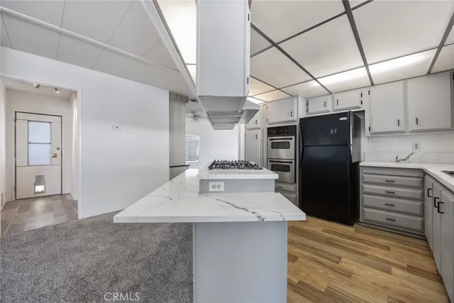 a kitchen with refrigerator and cabinets